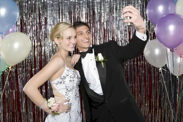 teenage boy and girl taking a picture at prom