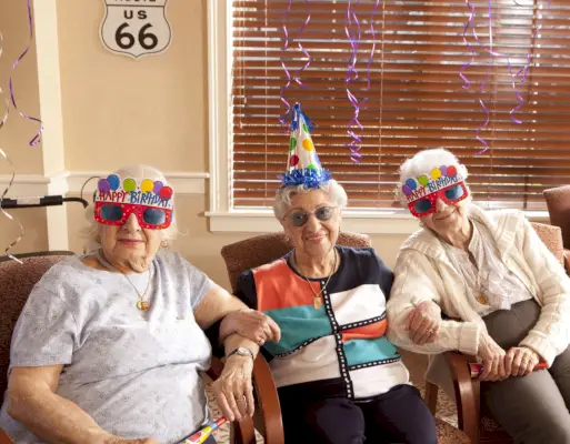 senior citizen ladies in birthday hats and party glasses