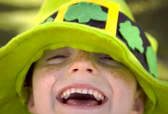 close up of smiling freckled child on st patrick
