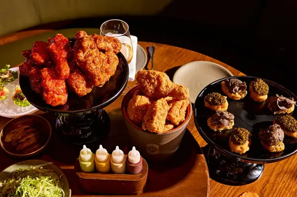 An assortment of dishes on a table including fried chicken and other items