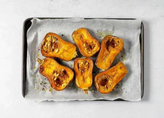 tray of roasted butternut squash on white background