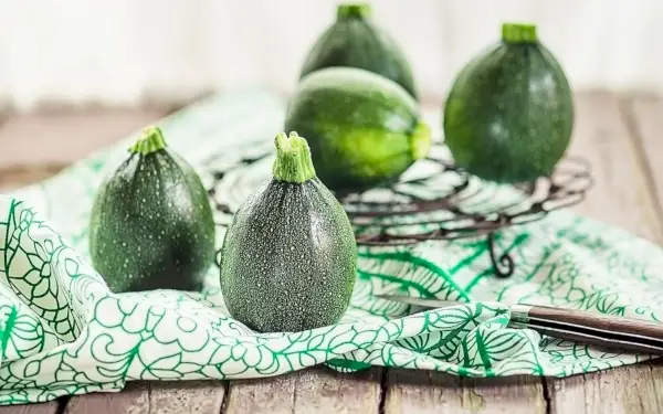an assortment of round type of squash on a counter