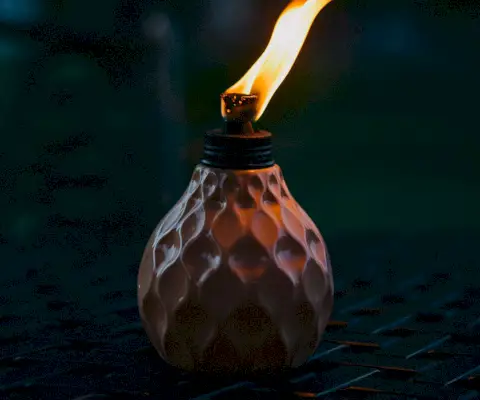 a blue plastic desktop electric fan on white wooden table with green blurred nature background