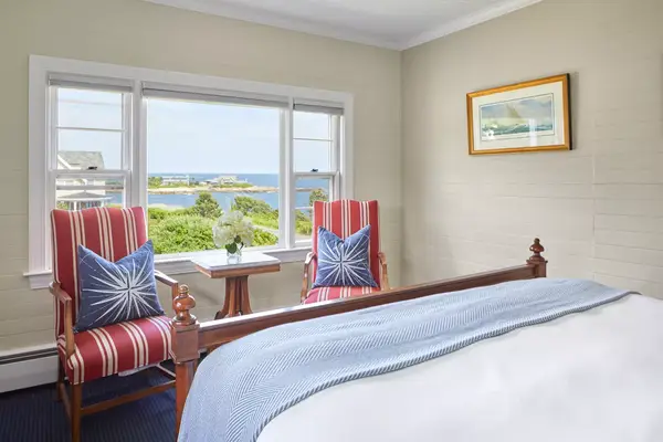 Red white and blue furnishing in a guest room over looking the ocean