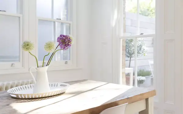 Flowers in vase on wooden table