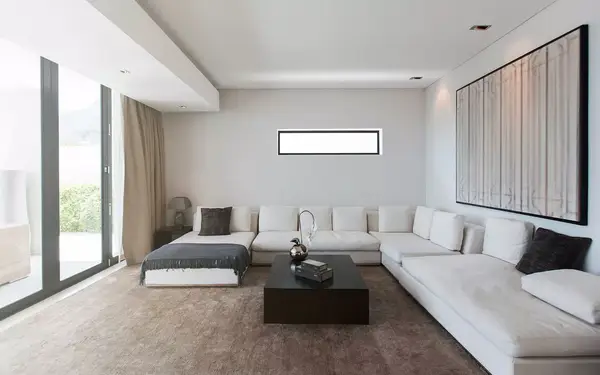 View of modern living room with sofas, coffee table and abstract painting
