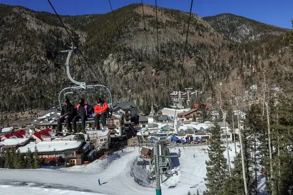 Skiers on a chairlift in New Mexico