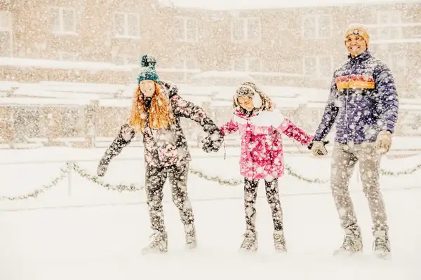 A family ice skates during heavy snow in Sun Valley, Idago