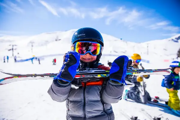 A young skiers holds his skis in Idaho