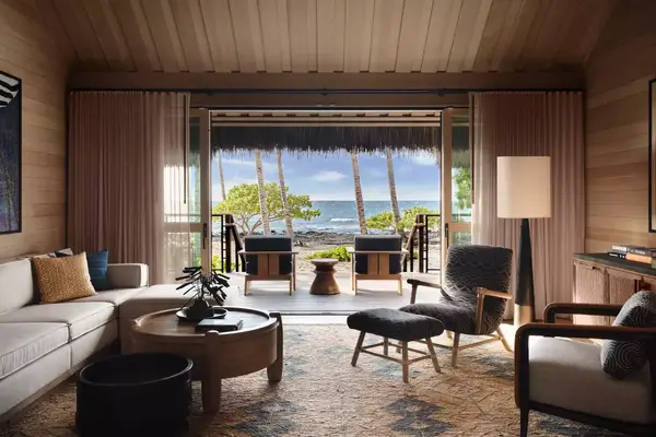 Luxurious interior of a beachside villa with a view of the ocean through open doors