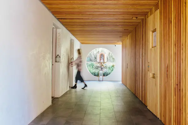 A person walking into a hotel room