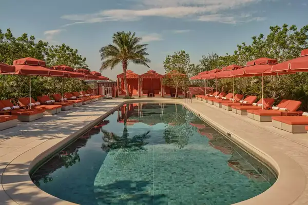 A pool with orange cabanas