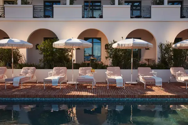 Poolside chairs and umbrellas at a resort in France
