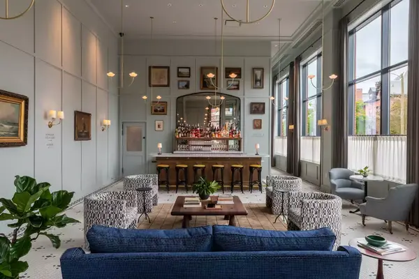 A bar aA hotel bar with colorful seating.