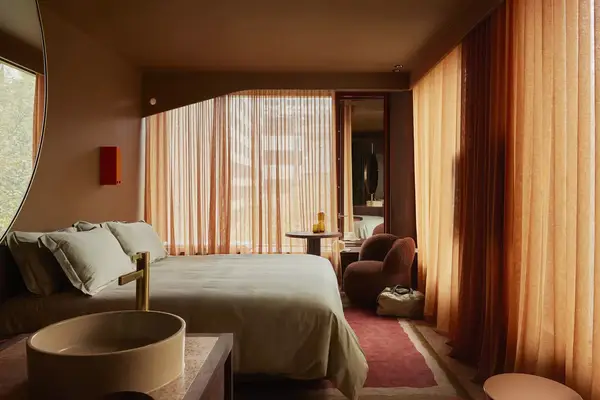 A guest room at a hotel in Melbourne, filled with sunlight