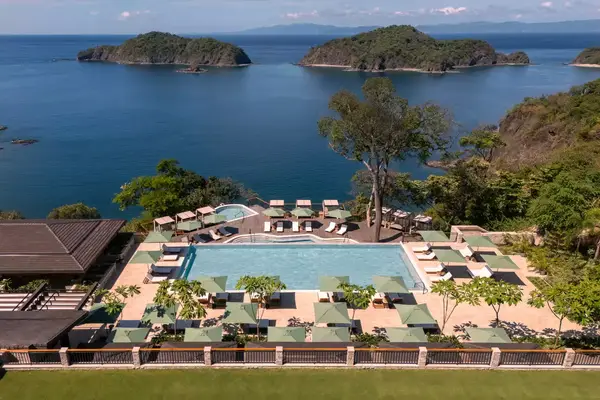 Overview of a resort pool in Costa Rica, with water views