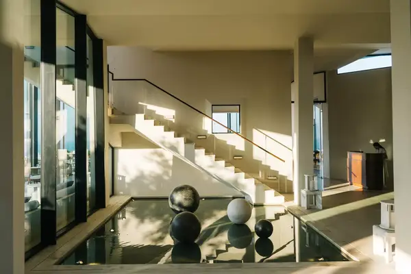 A sunlit room with artwork and neutral colors in Greece