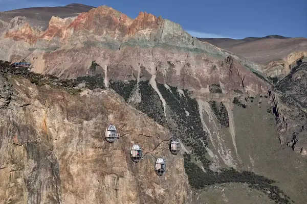 four metal pods attached to the mountain side