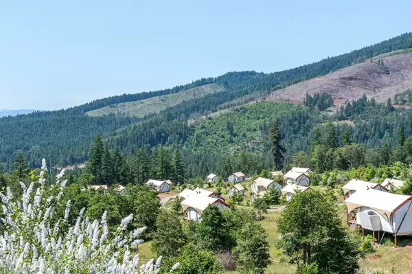 Scenic view of tents set up amidst a mountainous landscape