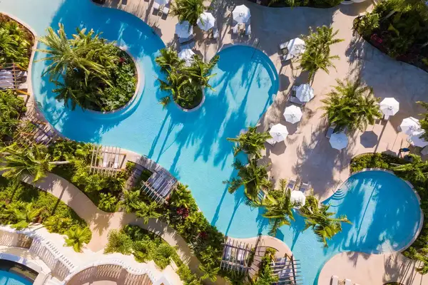Aerial view of an irregularly shaped swimming pool at a hotel resort 