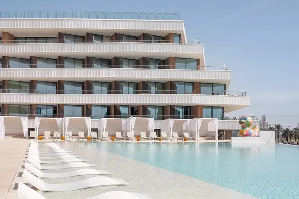 Luxury hotel with outdoor pool and lounge chairs in Barcelona