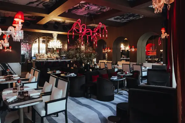 Interior of a stylish restaurant with modern decor and chandeliers