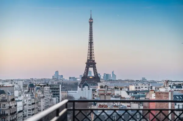 A view of the Eiffel Tower with surrounding city buildings seen from a rooftop