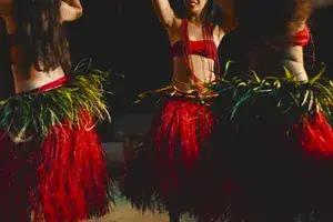 Three women in red French polynesian dance costumes