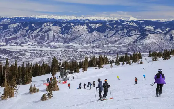 Skiers on a gentle slope at Aspen Snowmass Resort