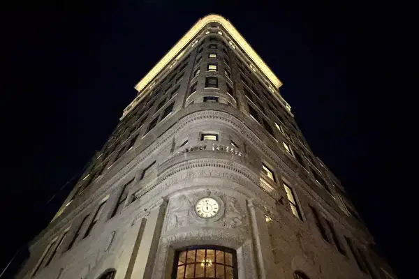 Exterior view of Nine Orchard hotel building seen at night, the building was a bank and built in 1912