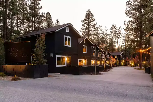 Noble + Proper cabins glow in the evening at Big Bear Lake in California