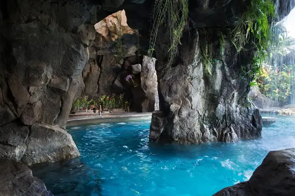 Grotto pool area with rocky walls and water features