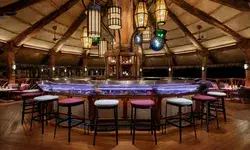 A dining and bar area with elegant lighting and wooden designs