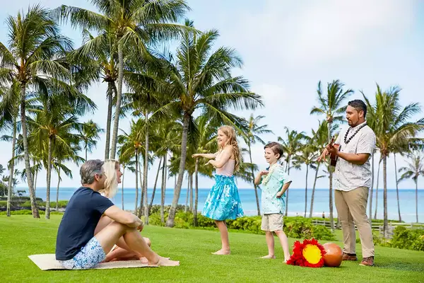 A family at a hula lesson at Montage Kapalua Bay