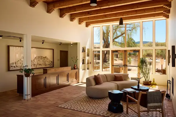 Lobby area with a reception desk, large windows, and seating area in a hotel