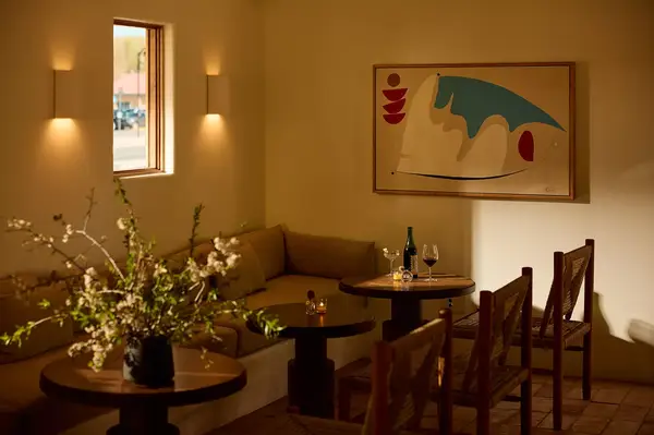 Cozy restaurant seating area with artwork and dim lighting