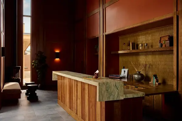 Hotel lobby with wooden interior front desk and decorative items on shelves