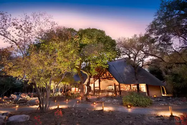 Exterior of the andBeyond Ngala Safari Lodge at night, voted one of the best hotels in the world