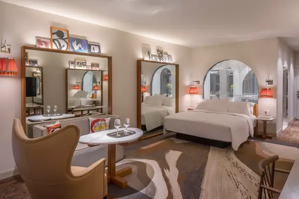 Guest room with several mirrors and art prints in the Lotte Hotel Seattle