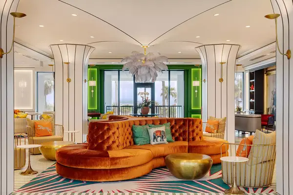 A stylish hotel lobby with vibrant seating and decorative lighting