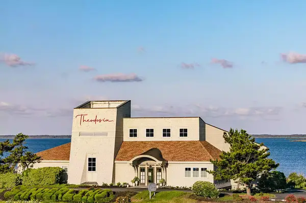 Main building of Theodosia at the Sanderling Resort near a body of water