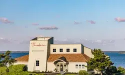 Main building of Theodosia at the Sanderling Resort near a body of water