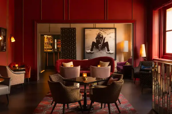 Lounge area with chairs and tables, bold photographic artwork on the wall