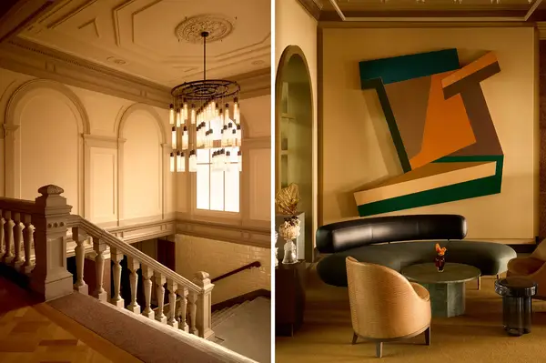 Interior view of a staircase with a chandelier and a modern lobby area with abstract art and stylish furniture