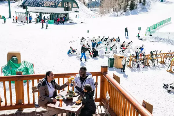 People enjoying beer post skiing and the lift area at Deer Valley Ski Resort