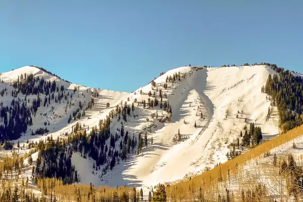 Snowy mountains in golden light during late winter in Park City, Utah