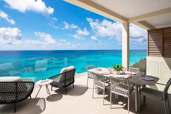 Balcony with seating and dining area overlooking the ocean