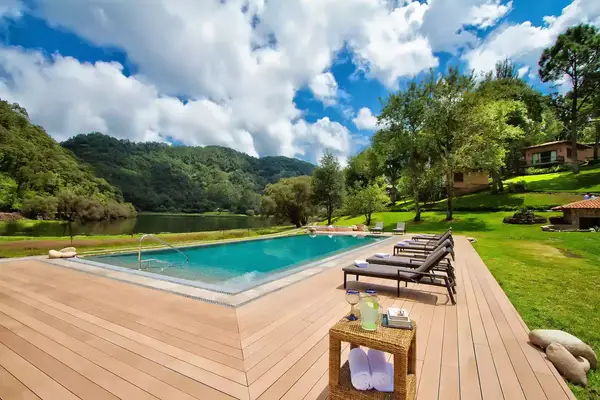 Pool deck surrounded by trees at Sierra Lago Resort & Spa Hotel