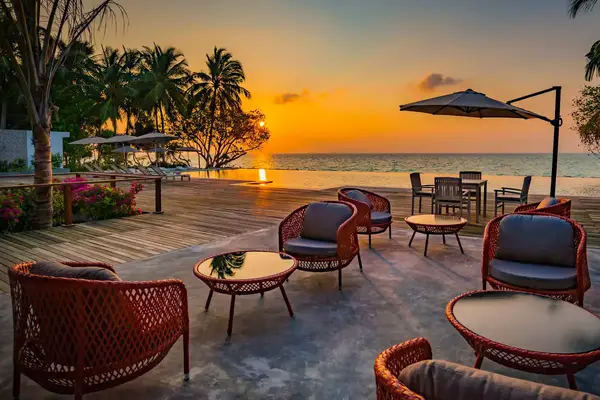 Deck chairs overlooking the ocean at sunset