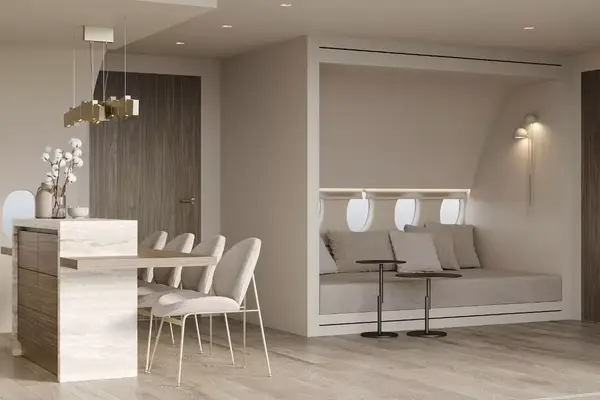 Interior kitchenette space with a dining bench inside a luxury outfitted Boeing 737 villa